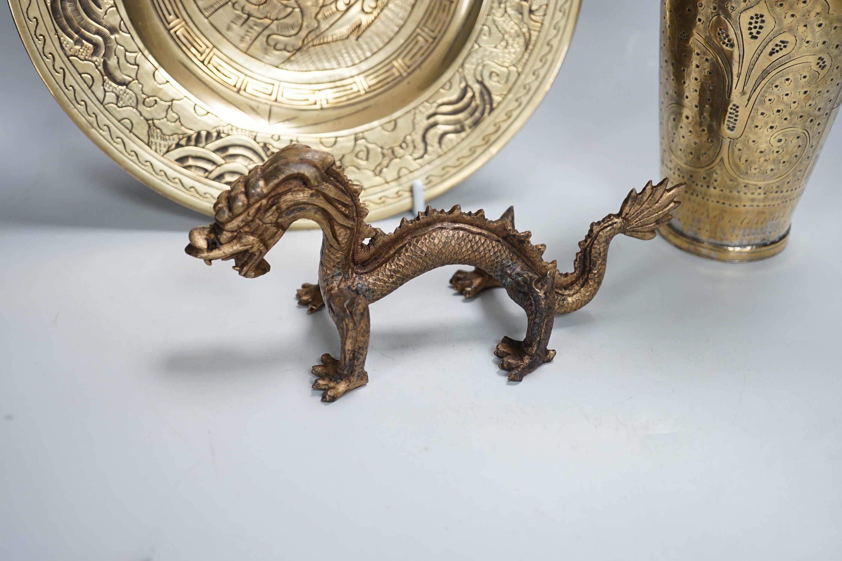 A Chinese engraved brass plate, large engraved beaker, koi fish and a dragon, the largest 24cm in diameter